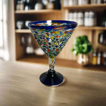 Confetti Rock Martini Glass with Blue Rim | Hand-Blown Mexican Barware - hand-blown pebble martini glass with blue rim on wooden bar
