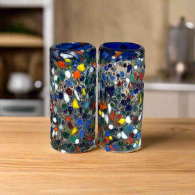 Confetti Double Shot Glass | Hand Blown Mexican Blue Rim - pair of hand-blown confetti-pattern double shot glasses with signature blue rims on wooden surface