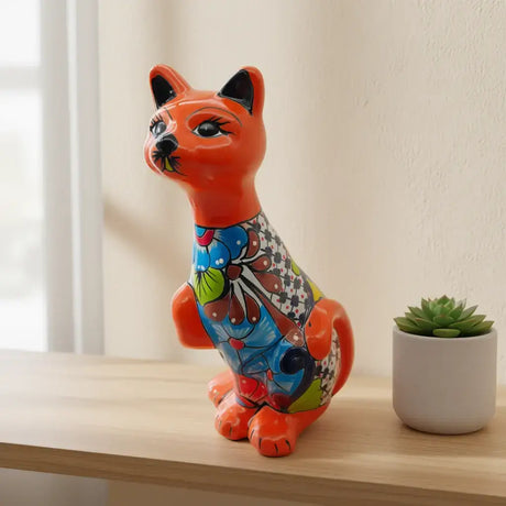 Talavera Cat Statue | Hand-Painted Mexican Ceramic Figurine - glossy orange hand-painted Talavera cat with multicolor floral body on shelf