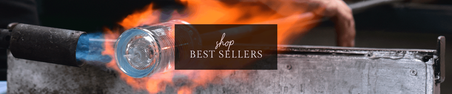 Glassblower shaping a glowing bottle by torch flame with 'Shop Best Sellers' overlay banner