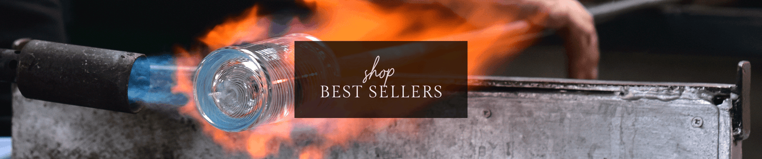 Glassblower shaping a glowing bottle by torch flame with 'Shop Best Sellers' overlay banner