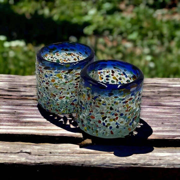 Hand-Blown Mexican Shot Glass | Confetti Triple Shot handcrafted in Guanajuato with blue-rimmed multicolor confetti glass, pair on rustic wood backdrop