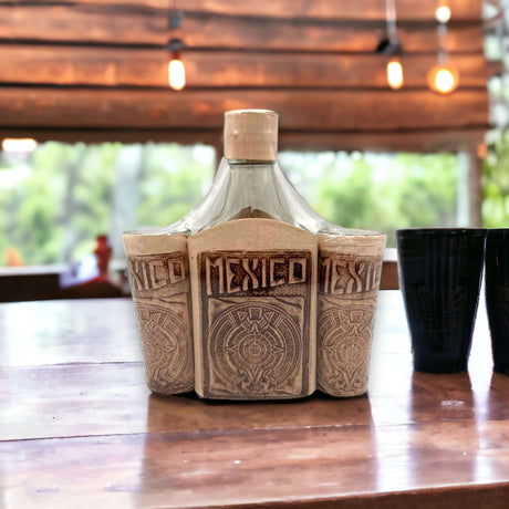 Mexican Flask & Shot Glass Set | Handmade Aztec Calendar Decanter displayed on wooden table with Talavera-style carved design