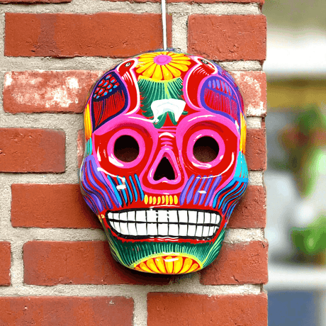 Colorful Calavera Skull | Hand-Painted Mexican Wall Art Decor — vibrant hand-painted Talavera skull with floral motifs on brick wall