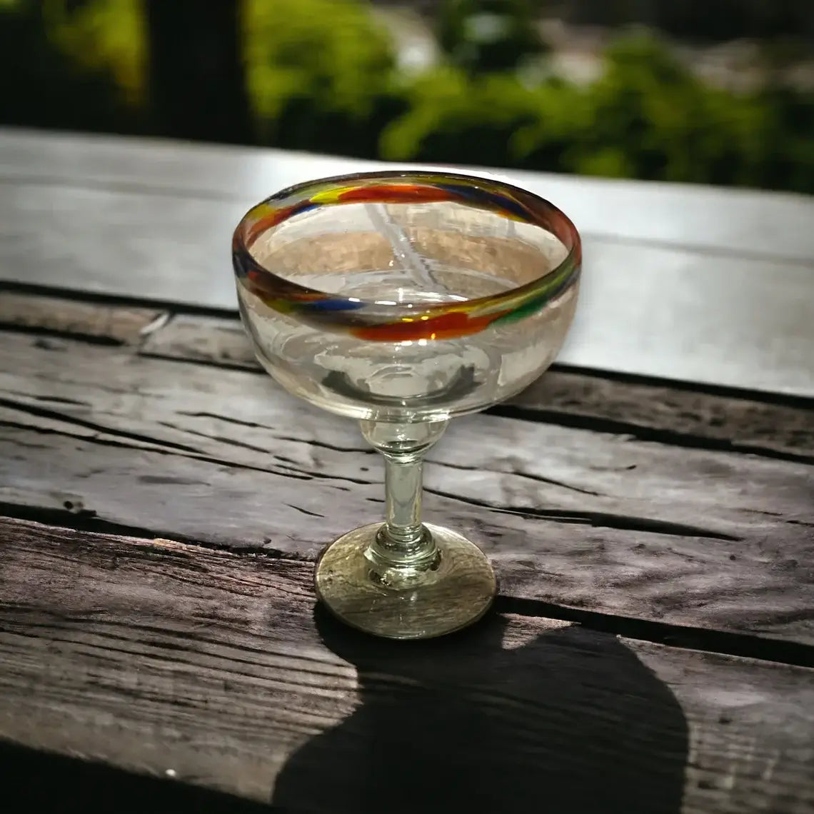 Hand-Blown Colorful Margarita Glass | Confetti Rim on wooden table, hand-blown lead-free glass with colorful confetti rim