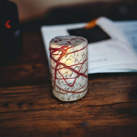 Mexican Hand Blown Drinking Glasses | Elegant White and Red hand-blown tumbler with white crackle finish and red swirl details on wooden table