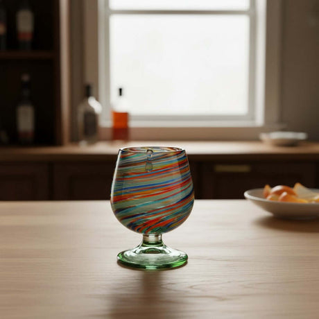 The Talavera Hub hand-blown Mexican shot glass with confetti swirl design in red, blue, green, and amber glass.