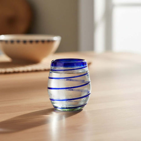 The Talavera Hub hand-blown stemless wine glasses with cobalt blue spiral design. Clear recycled glass, 12 oz capacity.
