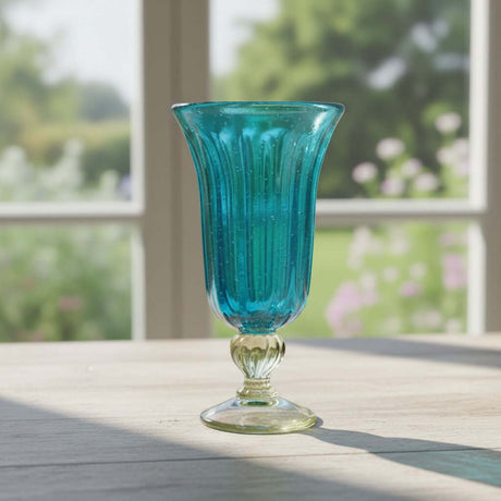 The Talavera Hub hand-blown aqua teal fluted glass sundae dish with a clear base and stem. 7" tall.