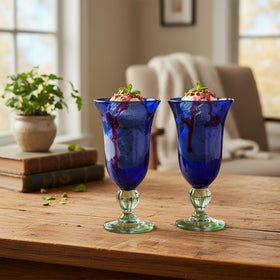 The Talavera Hub two hand-blown cobalt blue glass goblets with clear textured stems and bases. Perfect for desserts.