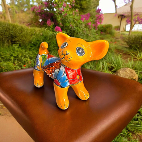 Alt Tag: Hand-Painted Talavera Chihuahua Statue | Mexican Ceramic Animal Decor (Medium) hand-painted orange floral chihuahua on outdoor bench