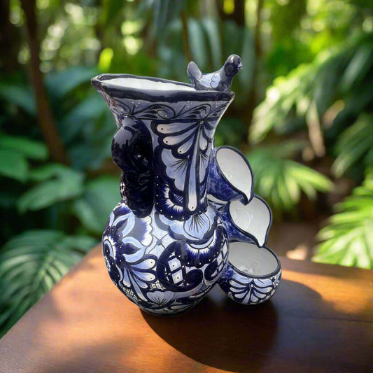 Handmade Talavera Fountain | Blue and White Mexican Ceramic Decor hand-painted blue and white wall fountain with bird spout in garden setting
