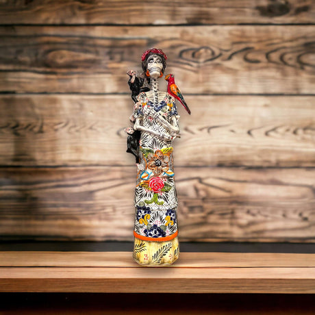 Talavera Skeleton Woman | Handmade Day of the Dead Pottery (Medium) hand-painted Talavera skeleton woman with floral patterns and parrot, Guanajuato