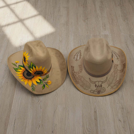 The Talavera Hub two tan cowboy hats, one with sunflowers, the other with etched bull skull and horseshoes.