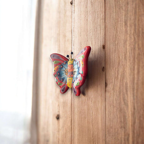 Talavera Butterfly Wall Hanging | Petite Animal Decor - hand-painted multicolor Talavera butterfly on wood wall, artisan Mexican pottery piece