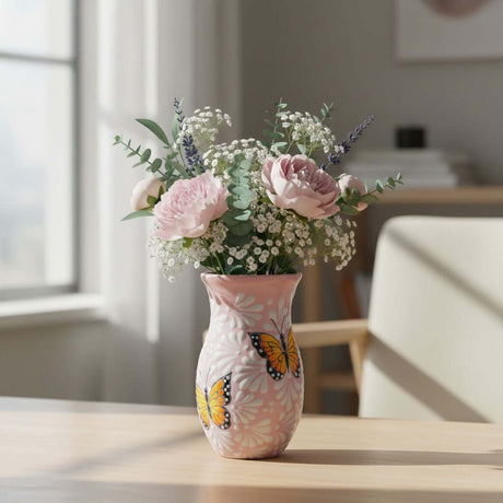 The Talavera Hub pink and white ceramic vase with monarch butterfly motif and floral relief. Handcrafted in Mexico.