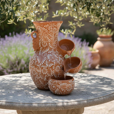 The Talavera Hub brown and white ceramic fountain with relief floral design, 20" tall, handcrafted in Mexico.