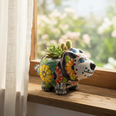 The Talavera Hub ceramic dog planter, hand-painted with vibrant floral patterns in red, green, yellow, and orange. Features Day of the Dead inspired details.