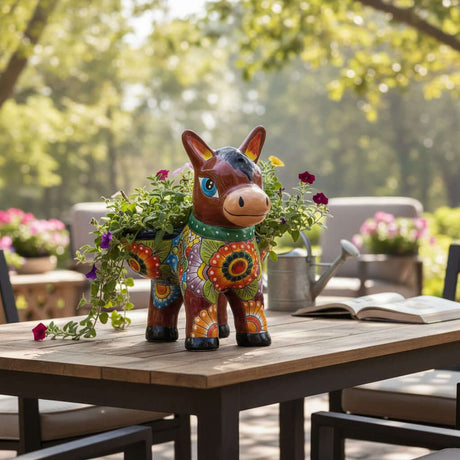The Talavera Hub Talavera Donkey Planter, a ceramic burro pot with hand-painted floral patterns in vibrant blues, greens, yel