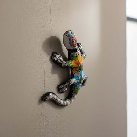 The Talavera Hub colorful ceramic lizard figurine with hand-painted floral patterns and skeletal details, Day of the Dead decor.