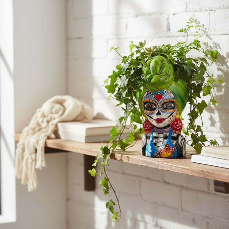 The Talavera Hub ceramic lady skull planter with green hair, colorful Day of the Dead face paint, and blue bikini.