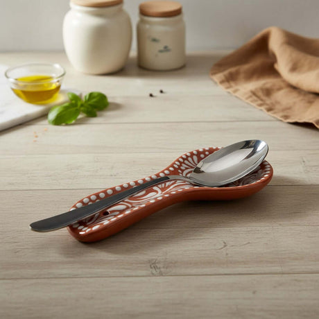 The Talavera Hub brown and white handcrafted ceramic spoon rest with floral relief design.
