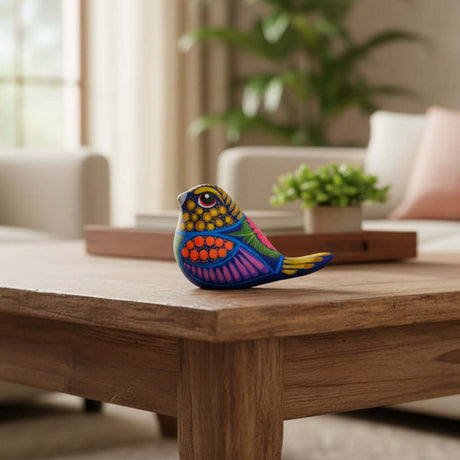 The Talavera Hub handcrafted ceramic bird figurine with vibrant, hand-painted Mexican folk art patterns on a wooden table.