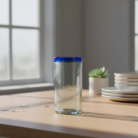 The Talavera Hub hand-blown clear glass tumbler with a cobalt blue rim, 18 oz capacity.
