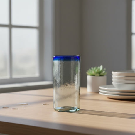 The Talavera Hub hand-blown clear glass tumbler with a cobalt blue rim, 18 oz capacity.