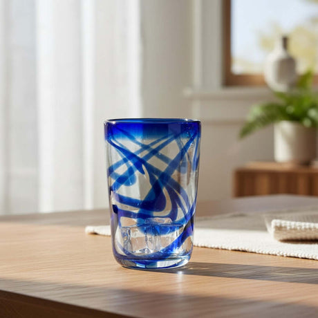 The Talavera Hub blue swirl hand-blown glass tumbler, 16 oz, 5" tall, recycled glass with cobalt blue swirls.