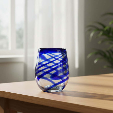 The Talavera Hub hand-blown stemless wine glass with blue swirls, made from recycled glass.
