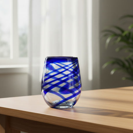 The Talavera Hub hand-blown stemless wine glass with blue swirls, made from recycled glass.