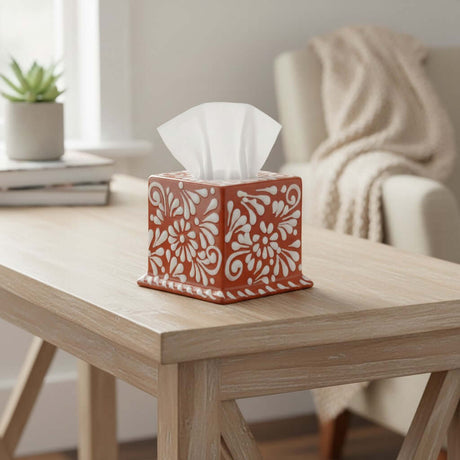 The Talavera Hub square tissue box featuring a hand-painted brown and white floral pattern on a wooden table.
