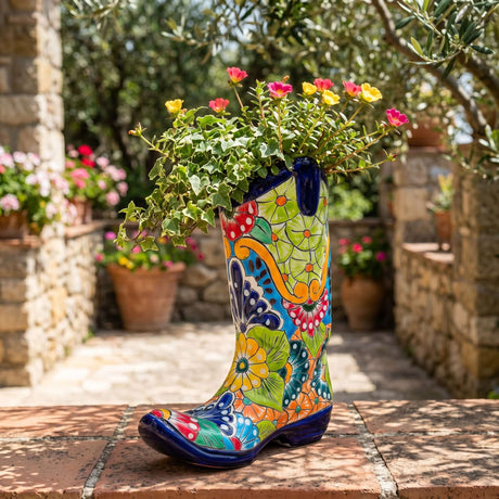 The Talavera Hub hand-painted ceramic cowboy boot planter with vibrant floral patterns in red, green, blue, and orange.