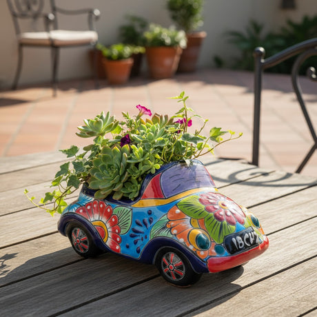 The Talavera Hub handmade ceramic car planter with colorful hand-painted floral folk art patterns and succulents.