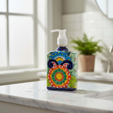 The Talavera Hub hand-painted ceramic soap pump with colorful Mexican floral patterns on a marble bathroom countertop.