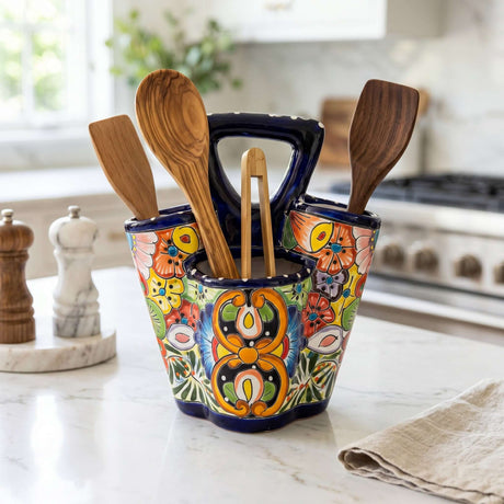 The Talavera Hub hand-painted ceramic utensil holder with vibrant floral patterns and three compartments on a kitchen counter.