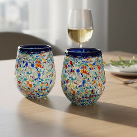 The Talavera Hub hand-blown stemless wine glass with blue rim and colorful confetti recycled glass texture. Holds 12 oz.
