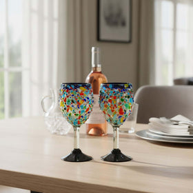 The Talavera Hub hand blown Mexican wine glasses with blue rim and colorful confetti design. Lead-free glass.