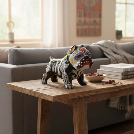 The Talavera Hub handcrafted ceramic dog statue with vibrant Day of the Dead folk art patterns on a wooden table.