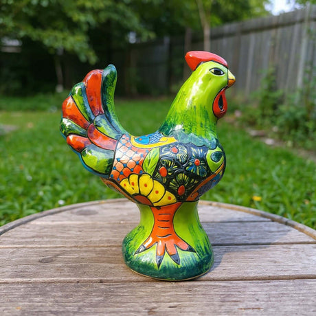 The Talavera Hub handcrafted green Talavera rooster statue with red comb, colorful tail feathers, and intricate folk art patterns.