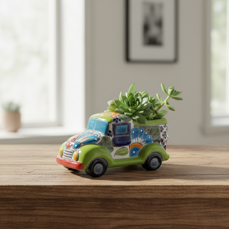 The Talavera Hub hand-painted ceramic car planter in green with colorful floral and geometric designs. Small size, ideal for succulents.