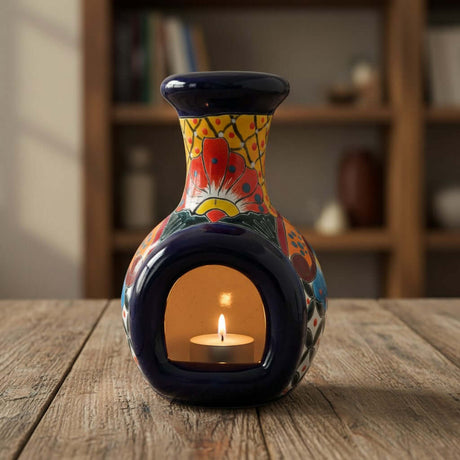 The Talavera Hub handmade Mexican ceramic chimney with vibrant hand-painted floral patterns and a lit tea light candle.