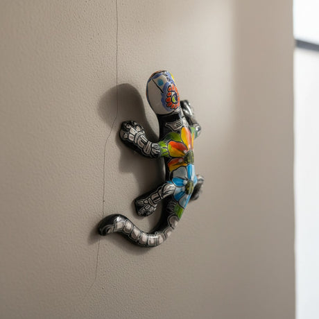 The Talavera Hub colorful ceramic lizard figurine with hand-painted floral patterns and skeletal details, Day of the Dead decor.