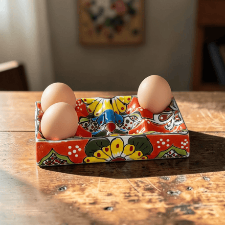 The Talavera Hub hand-painted ceramic egg holder with floral motifs in red, yellow, blue, and green.