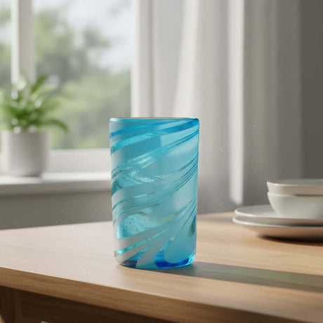 The Talavera Hub Handcrafted Mexican teal glass tumbler with white swirl design. Lead-free glass, 12 oz capacity.
