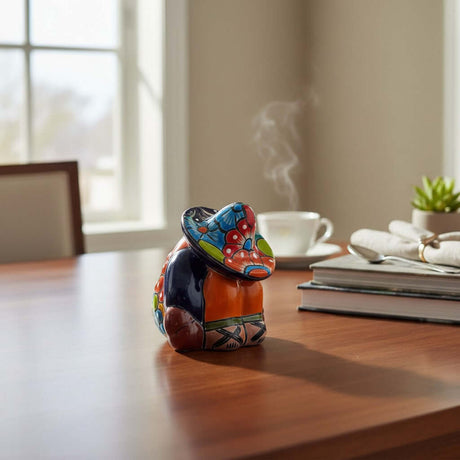 The Talavera Hub handmade Mexican pottery Panchito figurine featuring vibrant hand-painted patterns on a wooden table.