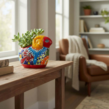 The Talavera Hub colorful ceramic ram planter with hand-painted floral details and succulents.