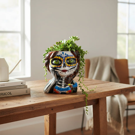 The Talavera Hub hand-painted ceramic skull girl planter with braided hair and Day of the Dead face paint.