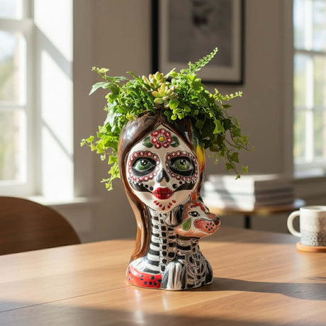 The Talavera Hub hand-painted ceramic skull planter with dog, featuring Day of the Dead motifs, vibrant colors, and intricate details.